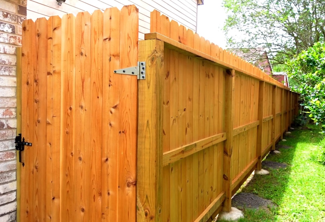 Cedar wood fence with gate hardware in residential property